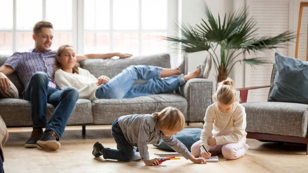 Family relaxing in a comfortable, well-heated living room